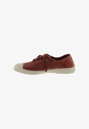 Red suede sneaker with cream rubber toe cap and textured sole. Features laces, stitching details, and a logo patch on the heel.