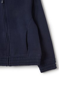 Navy blue zip-up sweatshirt featuring a soft texture, ribbed waistband, and side pockets. Design includes a straight cut and structured seams.