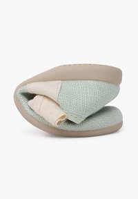 Chausson en tissu texturé, bleu clair et crème avec une semelle beige flexible, présentant un design enroulé pour un rangement facile et un confort optimal.