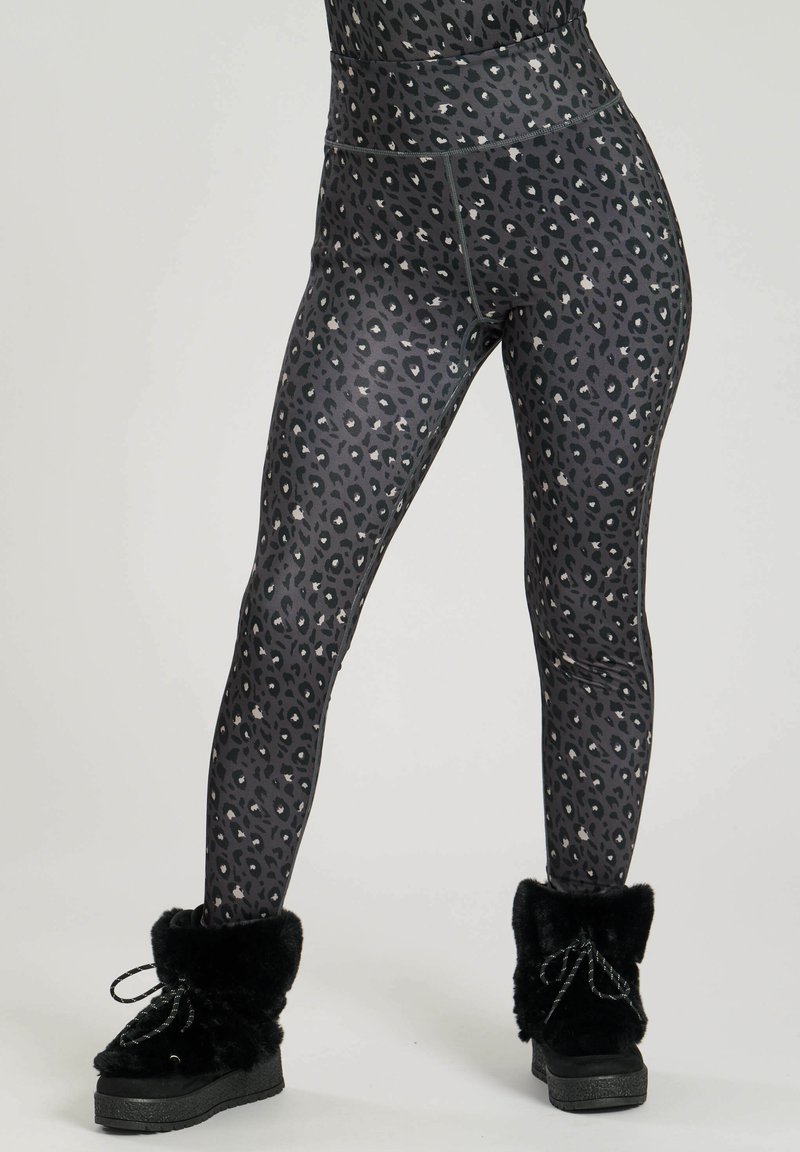 Black and gray leopard print leggings made from stretchy fabric, featuring a high waistband and a smooth finish. Paired with black fur-lined boots.