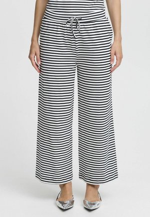 Pantalon large à rayures noir et blanc avec une taille élastique et un cordon de serrage, fabriqué en tissu doux et léger, offrant une coupe décontractée.