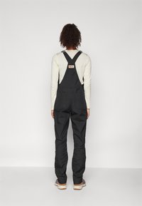 Fjällräven VARDAG DUNGAREE TROUSERS W - Hlače za na prostem - black
