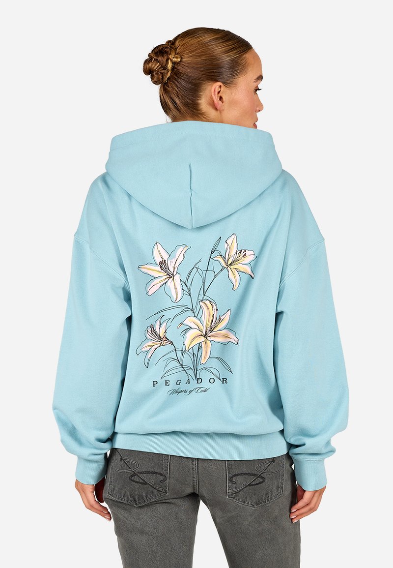 Égkék kapucnis pulóver virágmintával, a háta pink és sárga liliomokkal díszítve. Puha anyag és bordás mandzsetták, húzózsinórral ellátott kapucni.