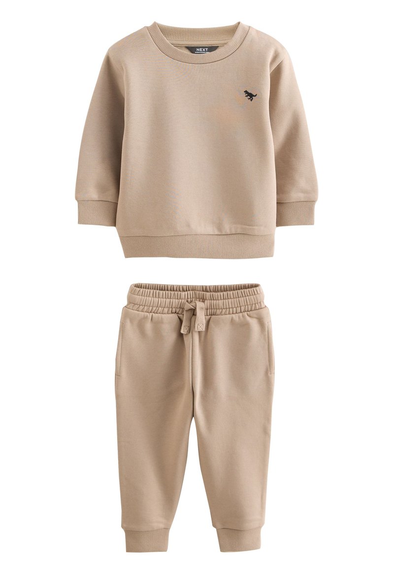 Beiges Sweatshirt- und Jogginganzug-Set aus weicher Baumwolle. Das Sweatshirt hat einen Rundhalsausschnitt und gerippte Bündchen; die Jogginghosen verfügen über einen elastischen Bund.
