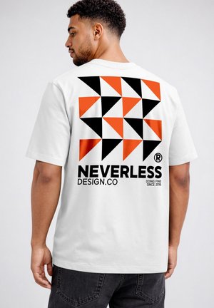 Man wearing white t-shirt with black and orange geometric triangles and text "NEVERLESS DESIGN.CO" on the back.