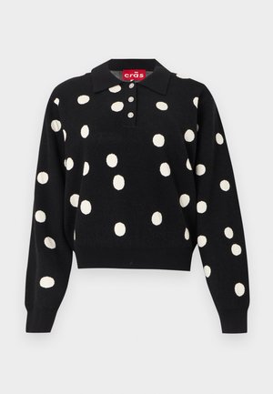 Fekete hosszú ujjú garbó pulóver fehér pöttyökkel, három gombbal az elején, bordázott mandzsettákkal és egy "cräs" feliratú gallércímkével.