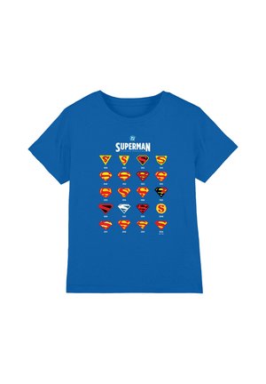 Blue t-shirt featuring a timeline of Superman logos from 1938 to 2024 arranged in a grid with years under each emblem.
