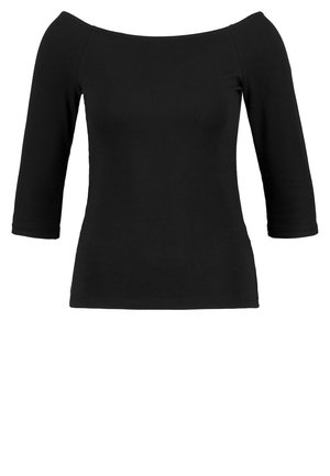 Haut ajusté pour femme noire avec manches trois-quarts et encolure bateau large.