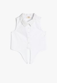 Weißes ärmelloses Shirt mit einem floralen Spitzenkragen, Knopfverschluss vorne, spitzem Saum und glattem Baumwollstoff. Strukturierter Schnitt ohne Ärmel.