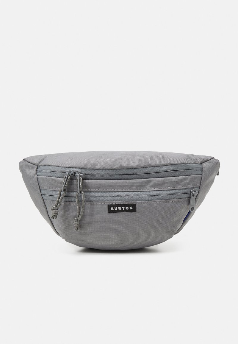 Gray fanny pack with a curved shape, featuring two external zippered pockets and a logo tag. Made of durable fabric with textured surface.
