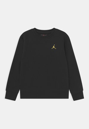 Zwarte trui van katoenen stof met een ronde hals, voorzien van een klein gouden Jumpman-logo op de borst en geribbelde boorden aan de mouwen.