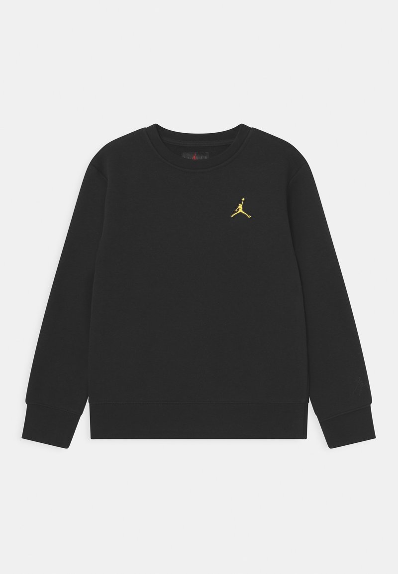 Sweat-shirt noir en tissu coton avec un col rond, affichant un petit logo Jumpman doré sur la poitrine et des poignets côtelés aux manches.