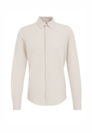 Camisa beige de manga larga con cuello abotonado, botones en el frente y un pequeño logotipo en el lado izquierdo del pecho. Hecha de una tela suave.