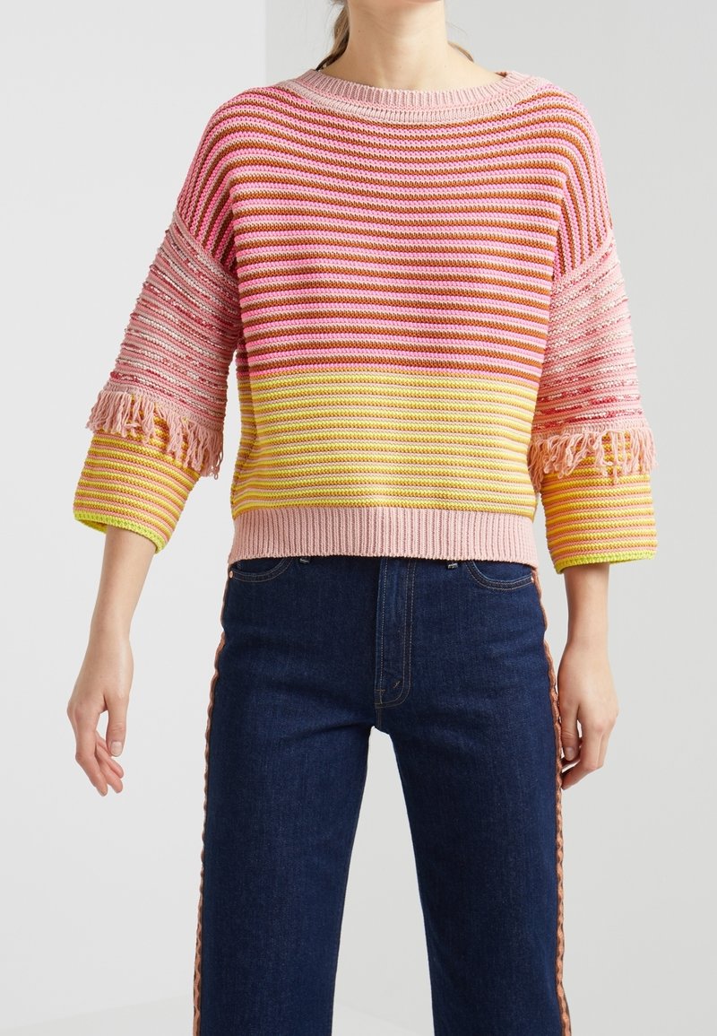 Multicolored striped knit sweater featuring pink, yellow, and coral hues, with fringe accents on the sleeves and a cropped design.