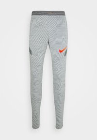 Leggings deportivos grises con un patrón de olas texturizado, logo de Nike en color naranja y un diseño ajustado con cinturilla elástica.