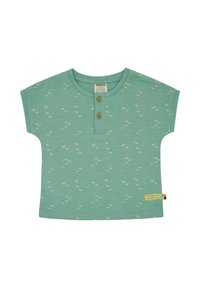 Short-sleeve green cotton shirt with small beige bird patterns, two wooden buttons at the neckline, and a colorful label at the side hem.