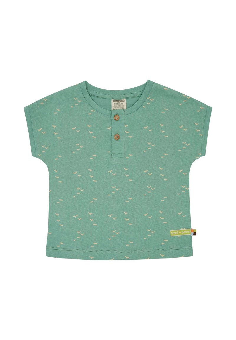 Short-sleeve green cotton shirt with small beige bird patterns, two wooden buttons at the neckline, and a colorful label at the side hem.