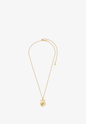 Kuldne kaelakee, millel on ümmargune värviline ripats rohelise tähega "T" ja tähtede aktsentidega, millel on kevadklamber.