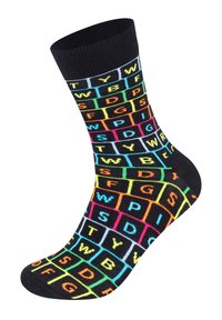 Chaussettes noires ornées d'un motif en grille de lettres et symboles colorés en rose fluo, vert, orange et bleu. Texture tricotée et longueur mi-mollet.