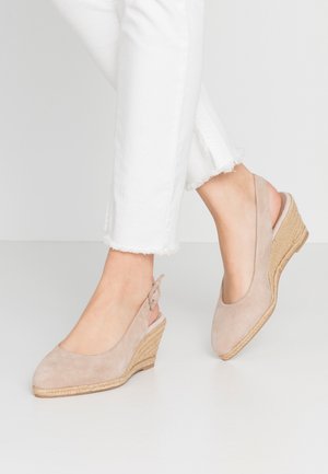 Beige suede wedge shoes with a slingback design, featuring a jute-wrapped heel and a smooth texture. The front has a rounded shape.