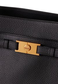 Black leather bag with a textured surface, featuring a gold-tone clasp and a matching leather strap for closure.