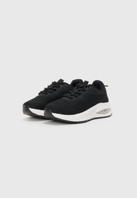 Black knit athletic shoes with white midsole, rounded toe, and textured upper. Features laces and an air cushioning detail on the heel.