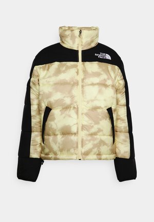 Veste matelassée beige et noire avec fermeture éclair intégrale, col montant, deux poches zippées et logo The North Face sur la poitrine.