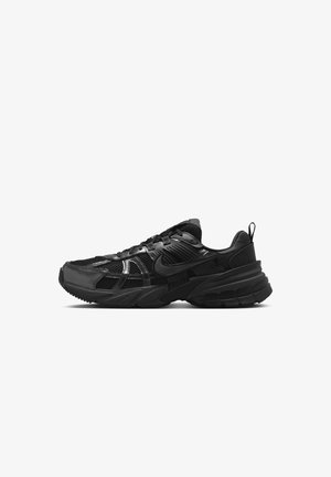 Czarny sportowy sneaker z siateczkową i syntetyczną cholewką, sznurowany, z grubą podeszwą i uchwytem na pięcie, widoczny z prawej strony.
