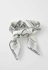 Selyem sál fekete vonalrajzzal egy világosszürke háttérrel, csomózott mintával és látható logóval az alján.