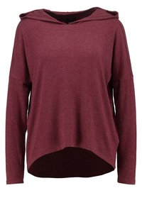 Burgundy long-sleeve hoodie with a relaxed fit, drop shoulders, and a curved hem. Made from soft, textured fabric.