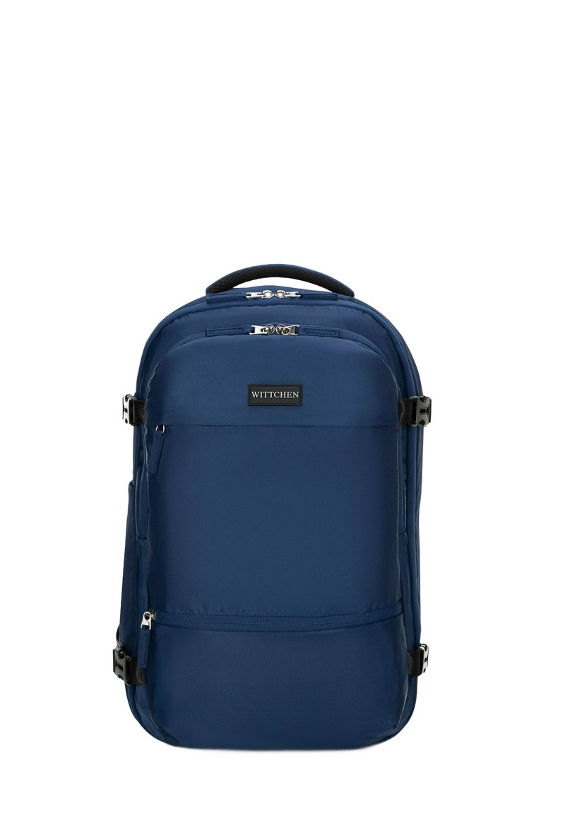 Blauwe Wittchen rugzak met meerdere ritscompartimenten, zijgespen en een gevoerde bovenhandgreep.