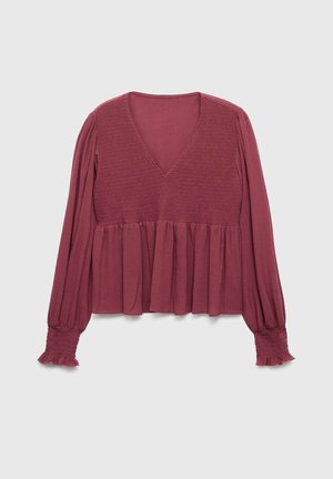 Long-sleeve mauve blouse with V-neck, shirred bodice, gathered waist, and smocked cuffs with ruffle detail.