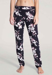 Black floral pajama pants featuring a stretchy waistband and a loose fit, decorated with white and pink flower patterns.