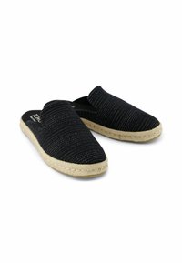 Black fabric slip-on espadrilles with a textured surface and woven pattern. Natural jute rope sole with a rounded toe design.