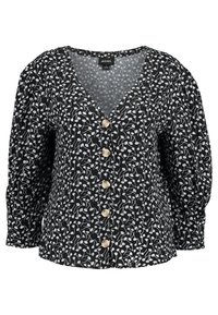 Blusa nera con un motivo floreale bianco e azzurro chiaro. Scollatura a V con cinque bottoni color crema e maniche lunghe a sbuffo. Tessuto leggero.