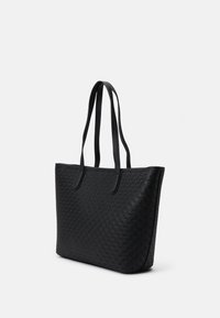 Black tote bag made of textured material featuring a diamond pattern, equipped with two sturdy handles and a spacious design.