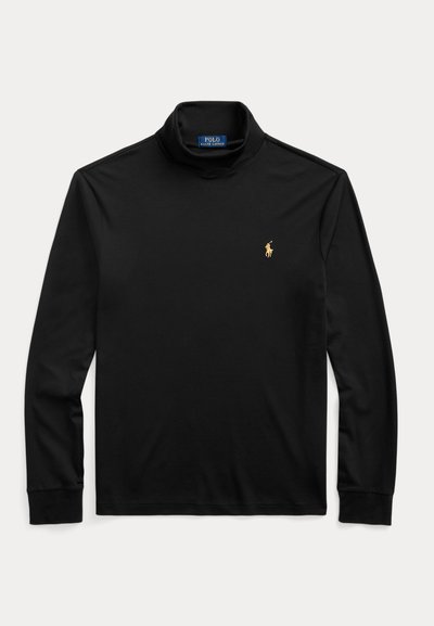 Mustad pika varrukaga kõrge kaelusega särk, vasakul rinnal väike kuldne Polo Ralph Laureni logo, paigutatud helele taustale.