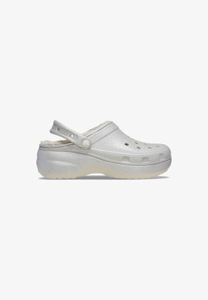 Silver glitter clogs with a fuzzy lining, open back, ventilation holes, and a textured strap. Slightly raised, rubber sole for grip.