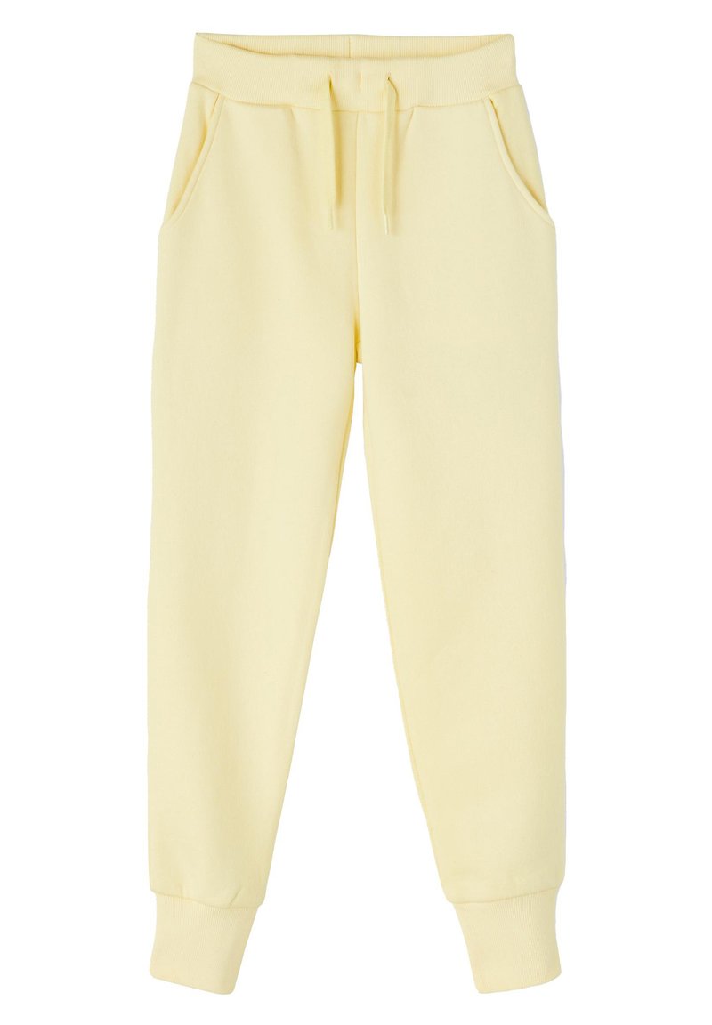 Pantalones de chándal amarillos de algodón con cintura elástica, cordón y bolsillos laterales. Piernas ajustadas con puños acanalados en el tobillo.