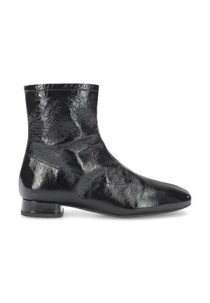 Glänzender schwarzer Knöchel-Stiefel mit niedrigem Blockabsatz und leicht spitz zulaufender Schuhspitze, zeigt Struktur und Falten auf glattem Leder.