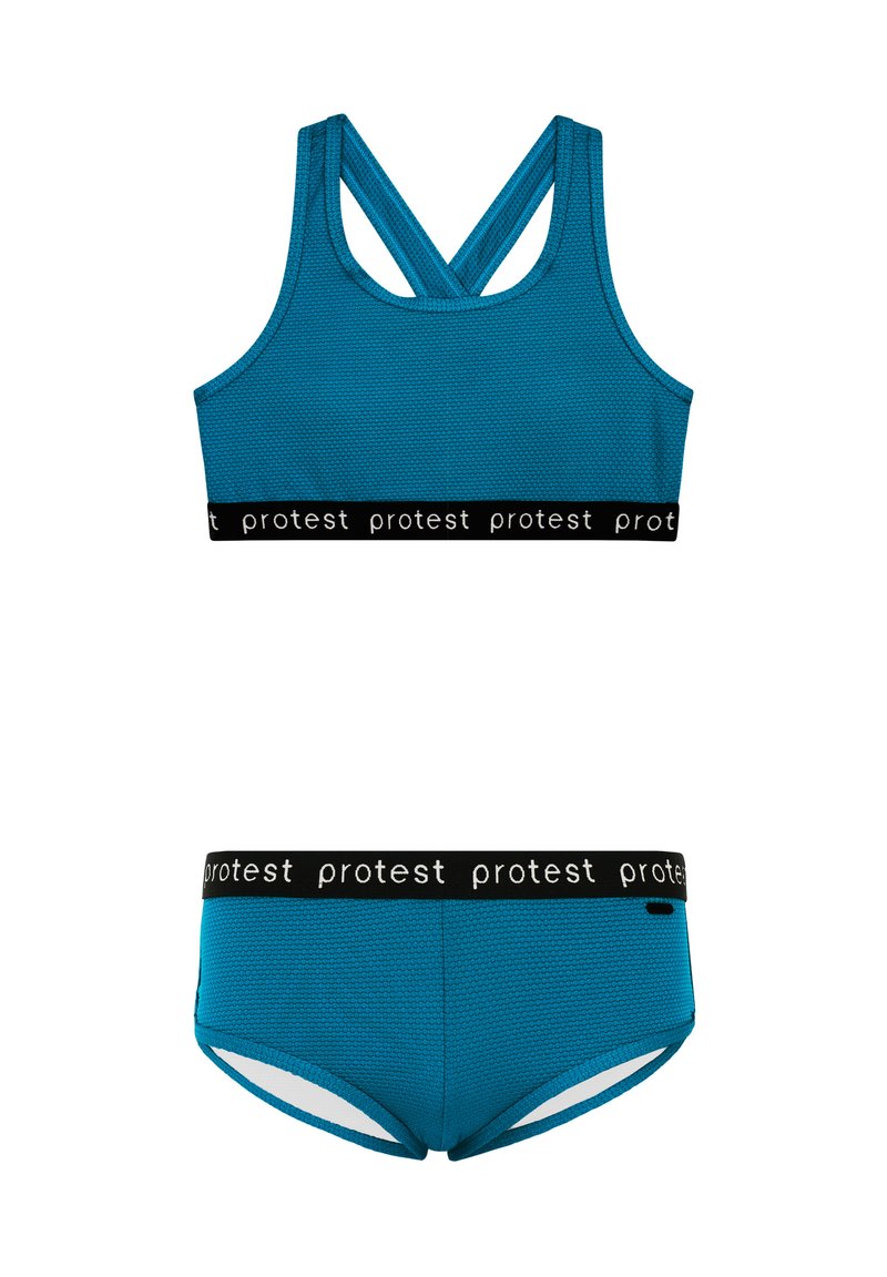 Turkiozinių sportinių liemenėlių ir atitinkančių kelnaičių rinkinys su tekstūruota medžiaga. Juodas juostelė su pakartotiniu "protest" prekinio ženklo ženklinimu. Kryžminis dizainas užtikrina atramą.