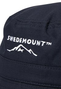 Marineblå bøttehat lavet af tekstureret stof med det hvide broderede logo "SWEDEMOUNT™" og et bjerggrafik på fronten.