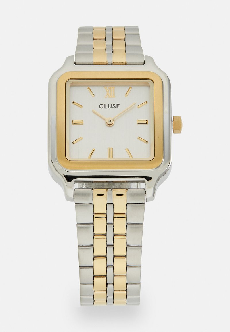 Square silver and gold-tone wristwatch with a white dial, gold accents, Roman numeral XII, and a two-tone metal bracelet.