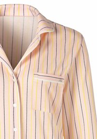 Button-up pajama shirt in light pink with vertical navy blue and yellow stripes. Features a collar, single chest pocket, and smooth fabric.