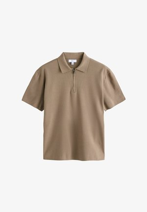 Short-sleeve polo shirt in light brown, features a half-zip closure, soft texture, and classic collar design. Smooth, minimalistic style.