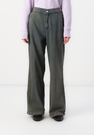 Wide-leg, soft green cotton pants with a high waist and front pockets, featuring a single button closure and subtle fading.