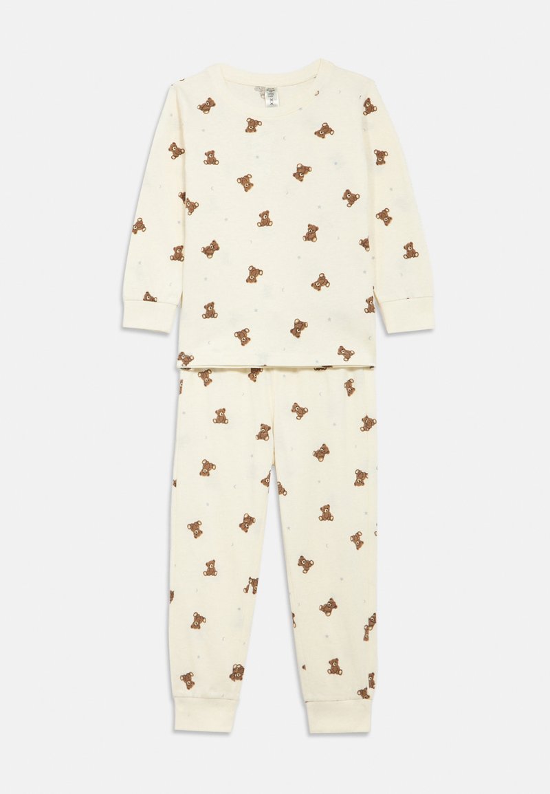 Completo pigiama in cotone color crema con maniche lunghe e polsini elasticizzati, caratterizzato da un motivo con orsetti sparsi tra piccole stelle.