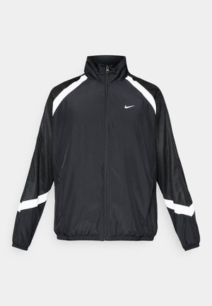Černá bunda s bílými detaily, plný zip vpředu, vysoký límec a síťované rukávy. Lehce provedená, sportovní design vhodný pro aktivní nošení.