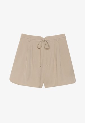 Beige shorts med en myk tekstur, med snøring i midjen, plisserte foran, og en avslappet passform. Runde sømmer og minimalt med tilbehør.