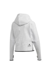Sweat à capuche gris clair avec manches longues, bordure noire aux poignets et à l'ourlet, fermeture éclair latérale et petit logo Adidas avec texte près de l'ourlet.